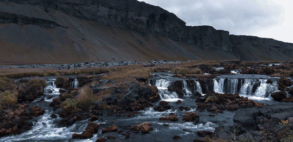 Scenic view of waterfall against sky