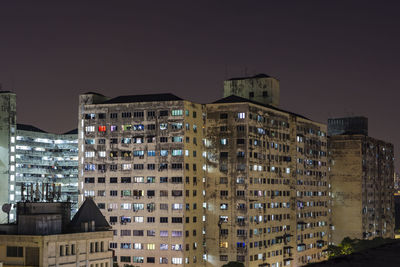 Low angle view of buildings against sky at night