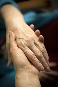 Close-up of females holding hands