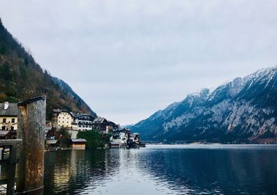 Scenic view of lake by buildings against sky