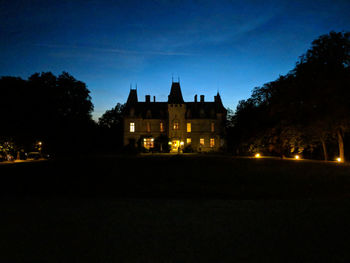 Illuminated building against sky at night