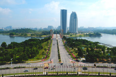 Panoramic view of city by river against sky