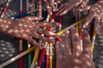 Cropped hands gesturing over sticks