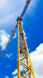 Low angle view of crane against sky