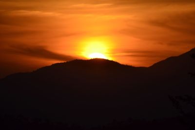 Silhouette of mountain range at sunset