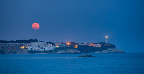 Scenic view of sea against clear sky at night