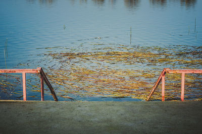 High angle view of railing by lake
