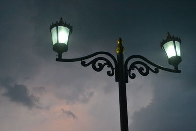 Low angle view of illuminated street light against sky