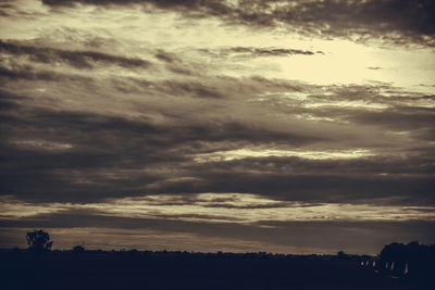 Scenic view of silhouette landscape against sky at sunset