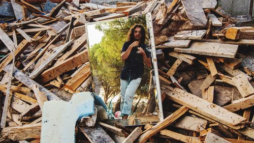 High angle view of young man reflecting on mirror