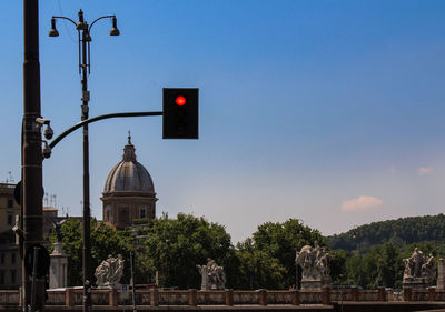 Statue in city against clear sky