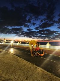 Man riding bicycle on road against sky