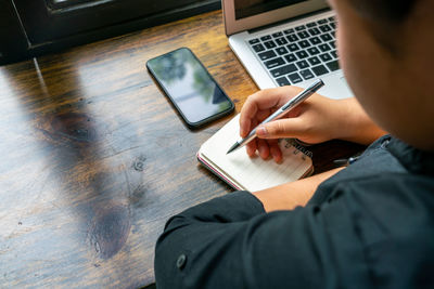 Midsection of man using mobile phone