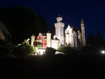 Low angle view of illuminated buildings against sky at night