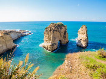 Panoramic view of rocks and sea against sky