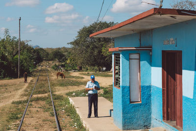 Rear view of man against building