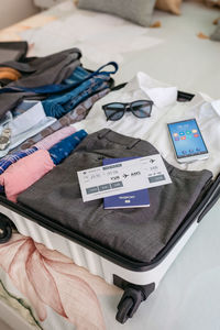 Businessman suitcase prepared for business trip with boarding pass