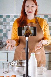 Portrait of young woman using mobile phone