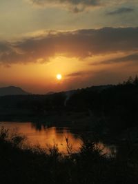 Scenic view of lake against romantic sky at sunset