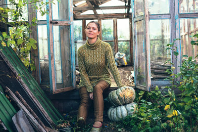 Portrait of smiling young woman sitting outdoors
