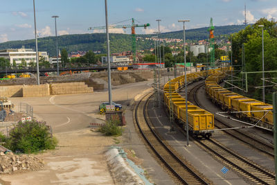 High angle view of train at railroad station against sky