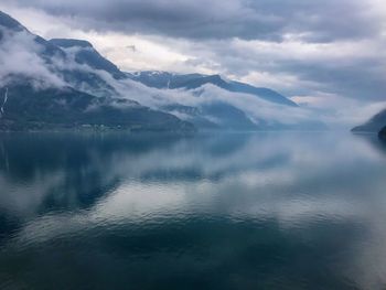 Scenic view of lake and mountains against sky