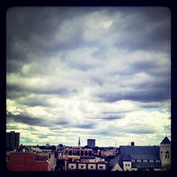 Buildings against cloudy sky