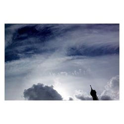 Trees against cloudy sky