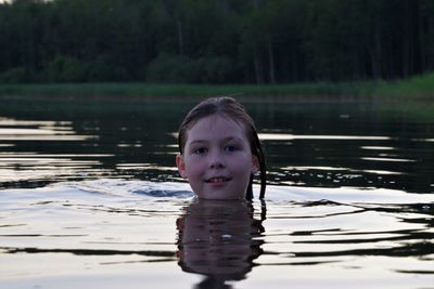 Portrait of boy swimming in lake