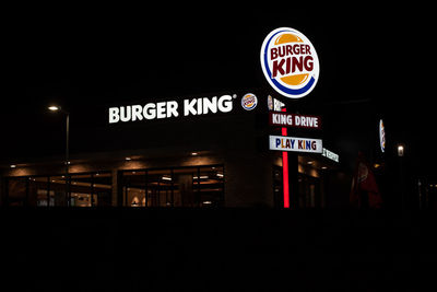 Low angle view of road sign at night