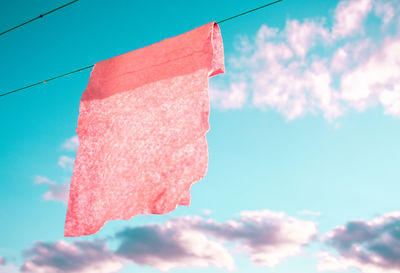 Low angle view of ice cream hanging against sky