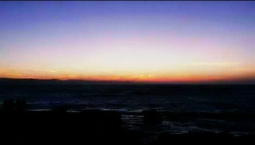 Scenic view of sea against sky at sunset