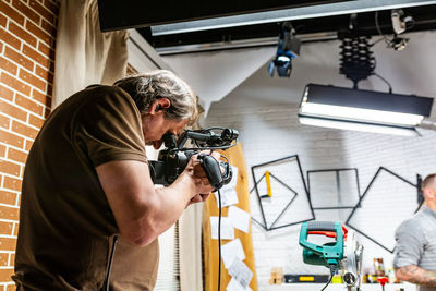 Man photographing working on table