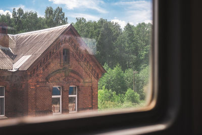 House seen through window of building