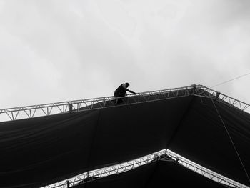 Low angle view of man standing on structure