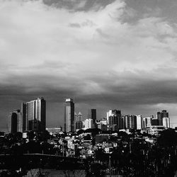 View of cityscape against cloudy sky