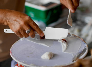 Midsection of man preparing food