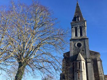 Low angle view of bell tower against sky