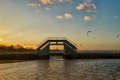 View of bridge over sea against sky during sunset