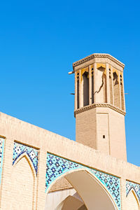 Low angle view of building against blue sky