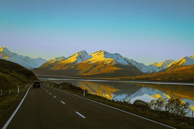 Road by mountain against clear sky