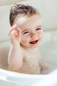 Close-up of cute baby girl in bathtub