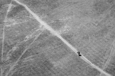Aerial view of person walking on track at field