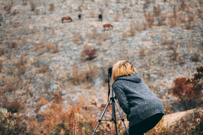 Rear view of woman photographing