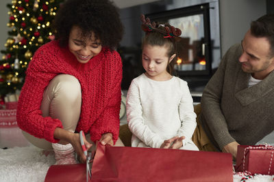 Women sitting on christmas tree