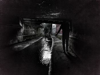 Rear view of man standing in tunnel