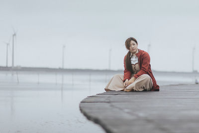 Young woman sitting on gaomei wetlands.