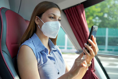 Portrait of young woman using mobile phone