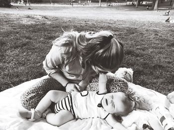 Mother and son relaxing on field