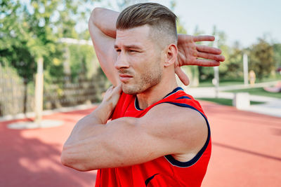 Side view of young man exercising in gym